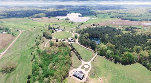 Aerial view of Lone Oaks Farm's woods, lake and pastures