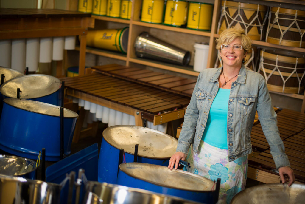Dr. Julie Hill in her classroom, surrounded by percussion instruments